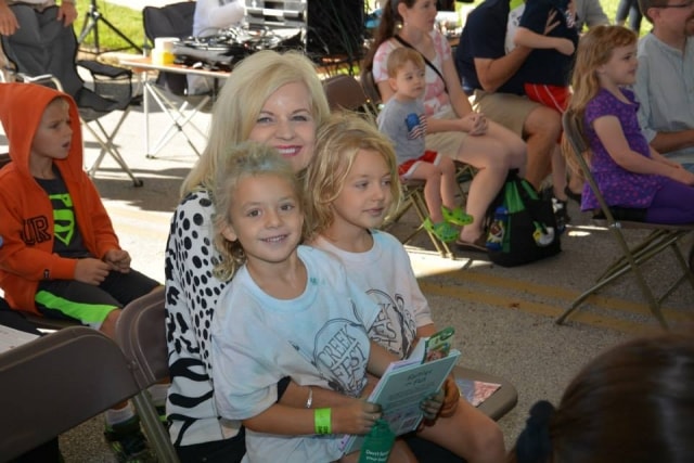 Woman with two children wearing CreekFest t-shirts at the festival