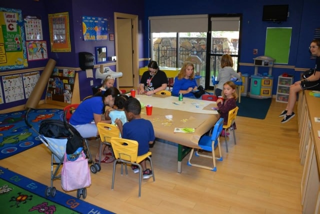 Children and volunteers at a classroom activity booth at CreekFest