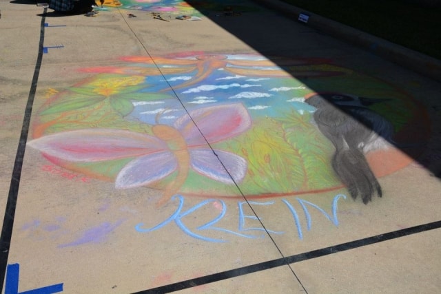 Klein chalk butterfly mural on pavement at CreekFest