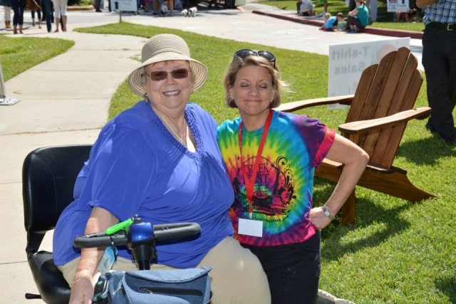 Two attendees smiling outdoors at CreekFest Houston
