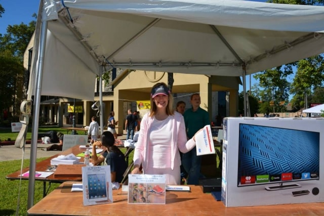 Volunteer at a technology vendor booth at CreekFest Houston