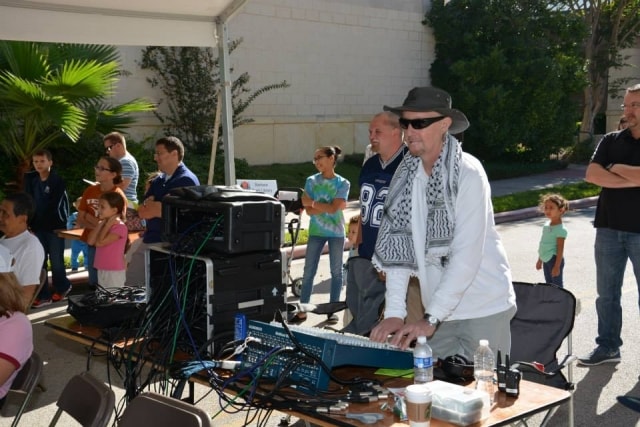 Sound engineer at the audio mixing board at CreekFest Houston