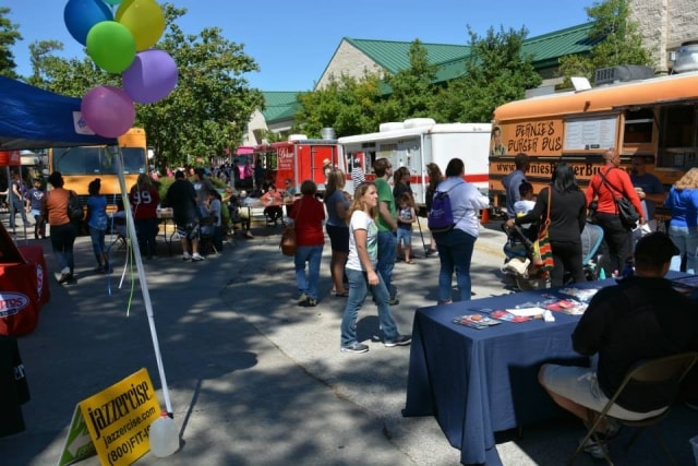 Crowds browsing food trucks and vendor booths at CreekFest Houston