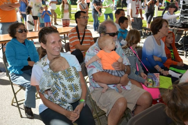 Families with babies seated in the audience at the CreekFest main stage