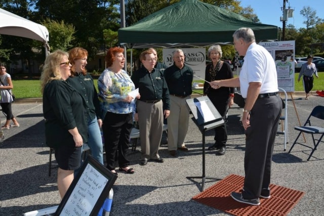 Texas Master Chorale singers performing outdoors with a conductor at CreekFest Houston