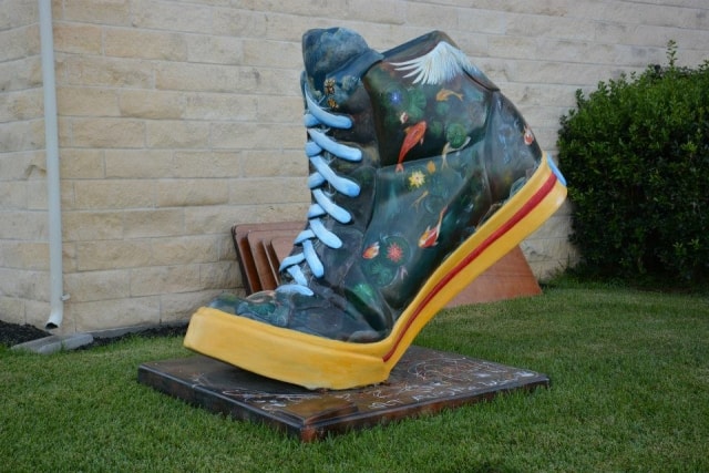 Large decorative painted sneaker sculpture on display at CreekFest Houston