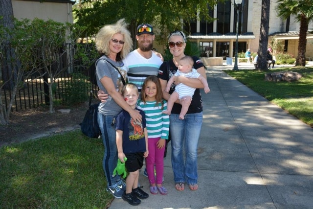 Multi-generational family of five posing together on the grounds at CreekFest Houston