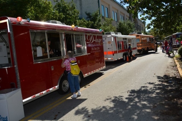 D-Luxe BBQ food truck with attendees ordering at the window at CreekFest Houston