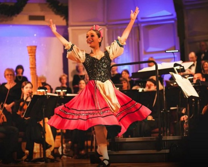 Solo dancer in traditional costume performing with orchestra at The Centrum