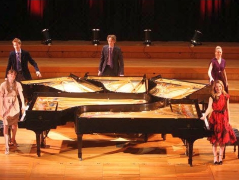 The Five Browns — five pianists with grand pianos on stage