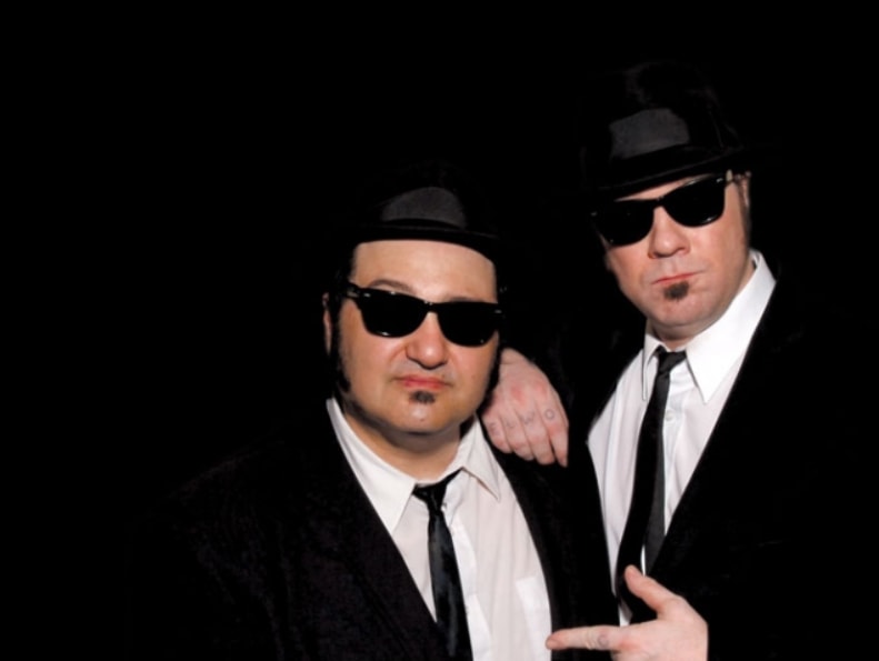 Blues Brothers tribute performers in black suits and sunglasses