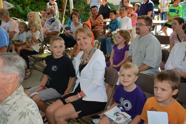Community audience gathered at an outdoor CreekFest event
